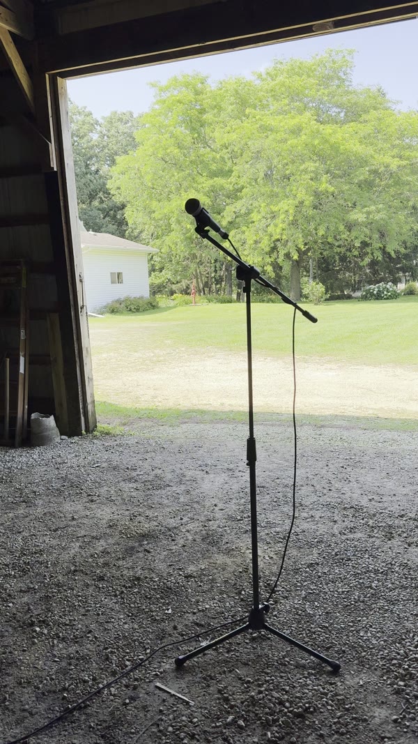 Mic stand silhouetted in a barn doorway